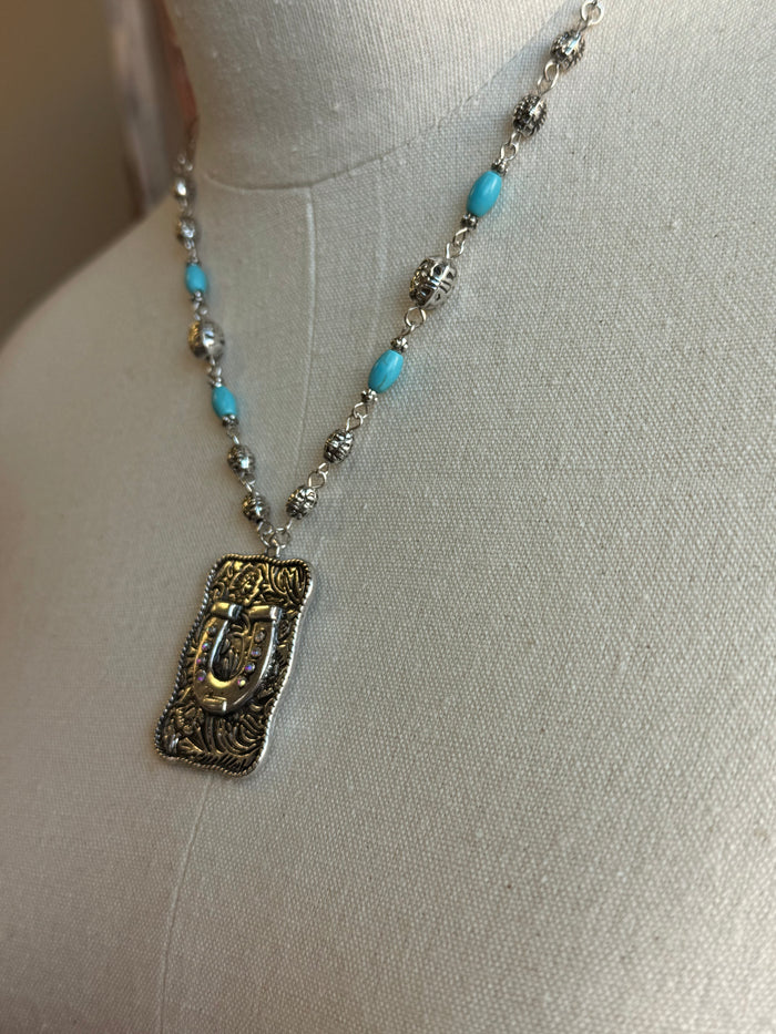 Silver-tone horse-shoe pendant on beaded chain with turquoise bead accents