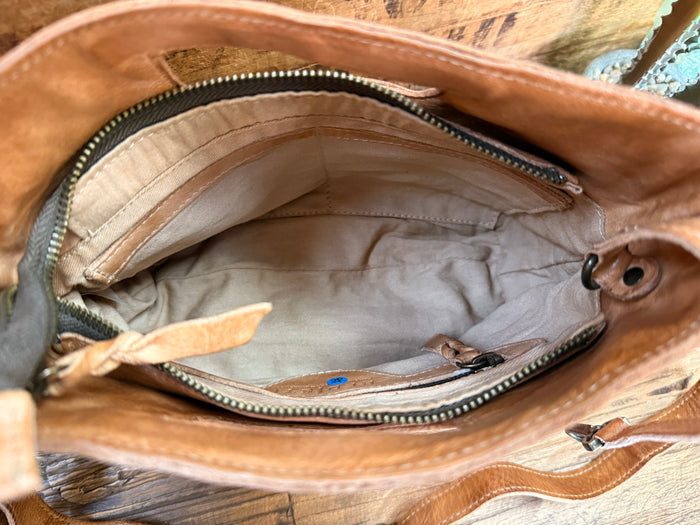 Keiki tan leather bag interior with zip top, lined base, and side pocket