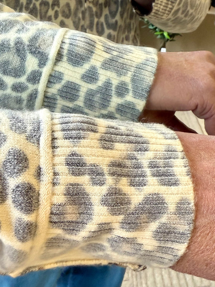 Leopard print cardigan sleeve detail with dark spots and ribbed cuff
