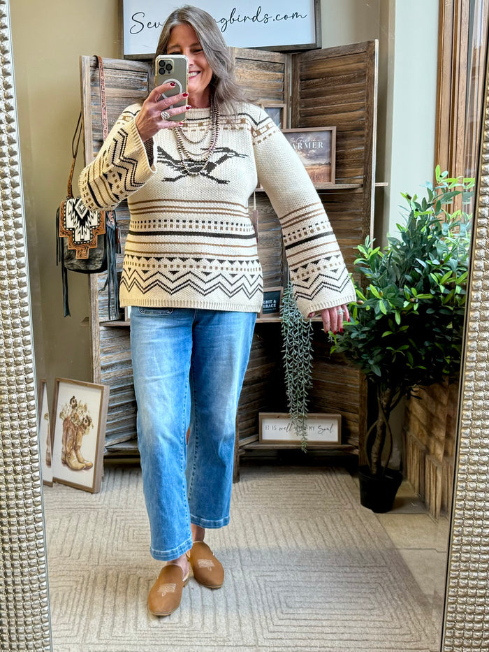Crew neck sweater in tan with black and cream Fair Isle pattern, long sleeves.