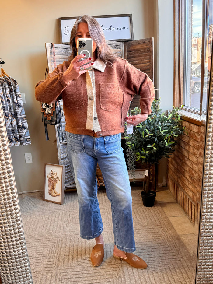 Rust-brown collared cardigan with cream contrast button placket and front pockets