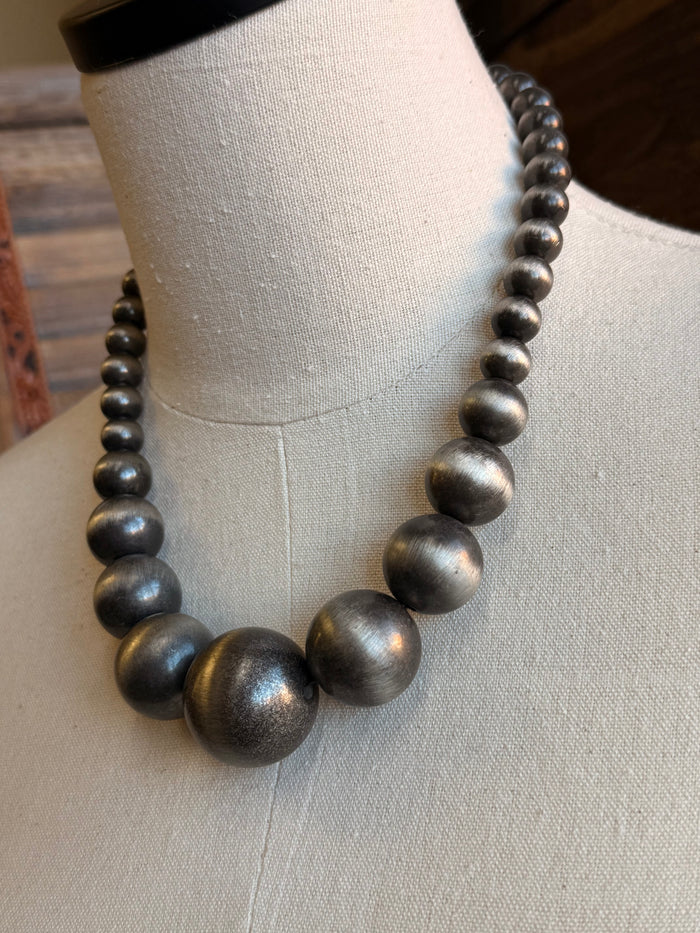 Silver metallic bubble gum pearl necklace detail with three large rounded beads