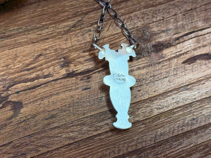 Turquoise cutout silhouette pendant on silver chain