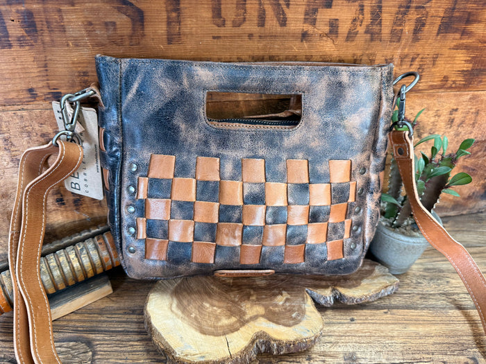 Distressed blue crossbody bag with tan checkerboard front and top handle opening