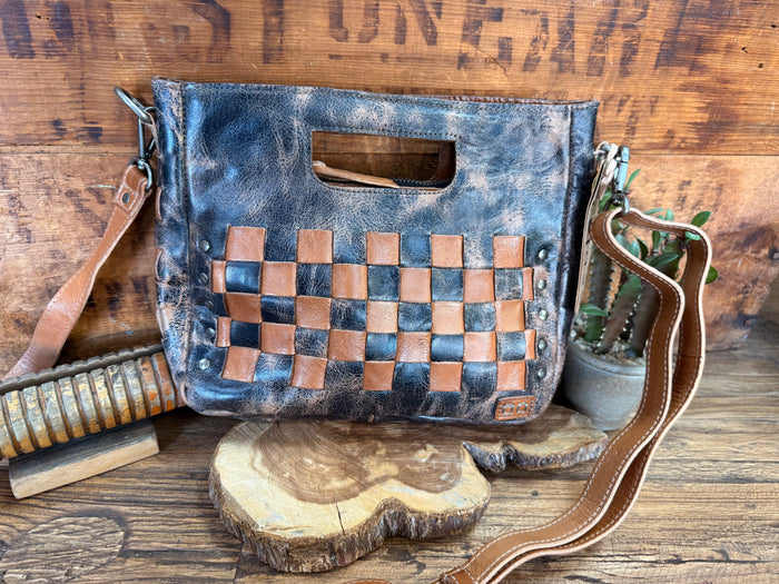 Distressed blue crossbody bag with tan checkerboard front pocket and brown strap