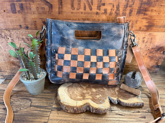 Distressed blue leather crossbody bag with tan checkered panel and front flap pocket