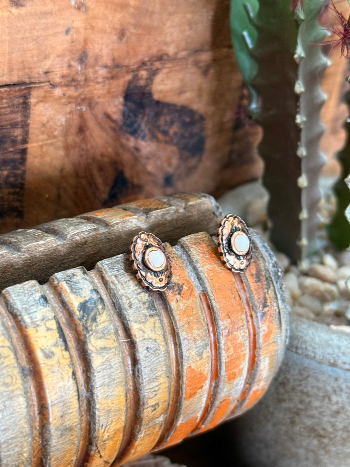 Copper concho stud earrings, circular shell-like center with textured floral frame
