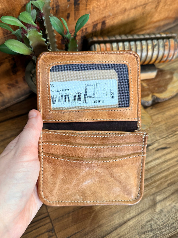 Tan leather wallet open with card slot and retail label, held in hand
