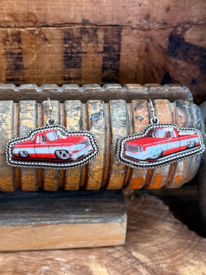 Silver hoop earrings with red truck charm, bordered with beaded rope detail