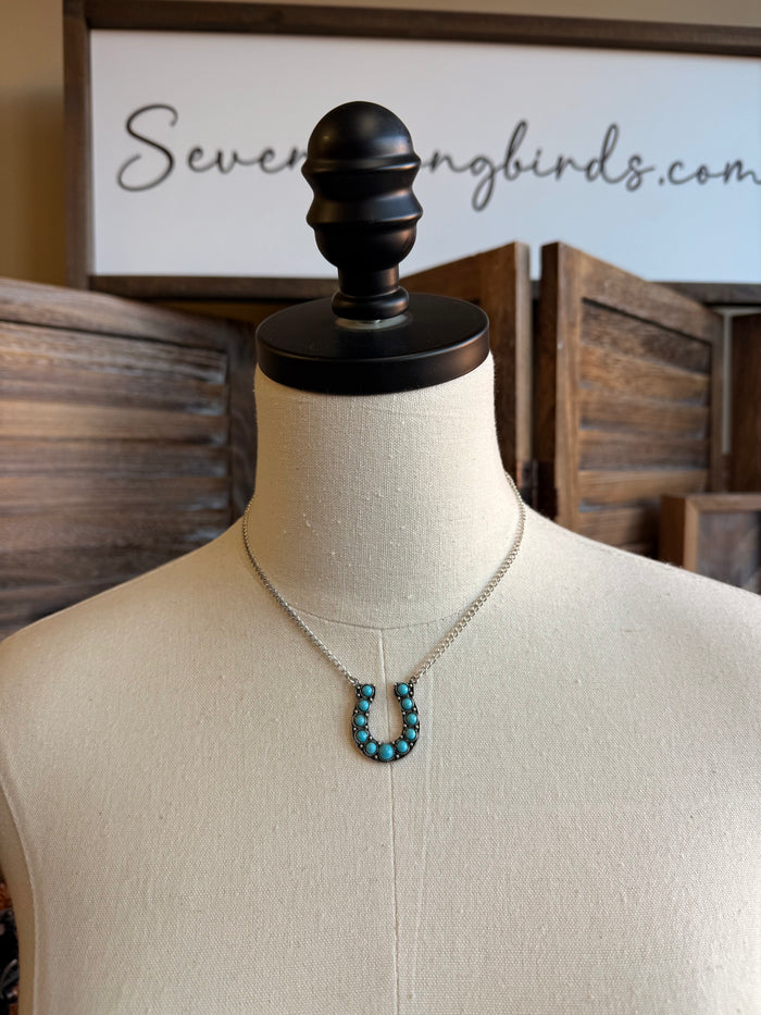 Turquoise horseshoe necklace with silver chain and U-shaped turquoise bead pendant