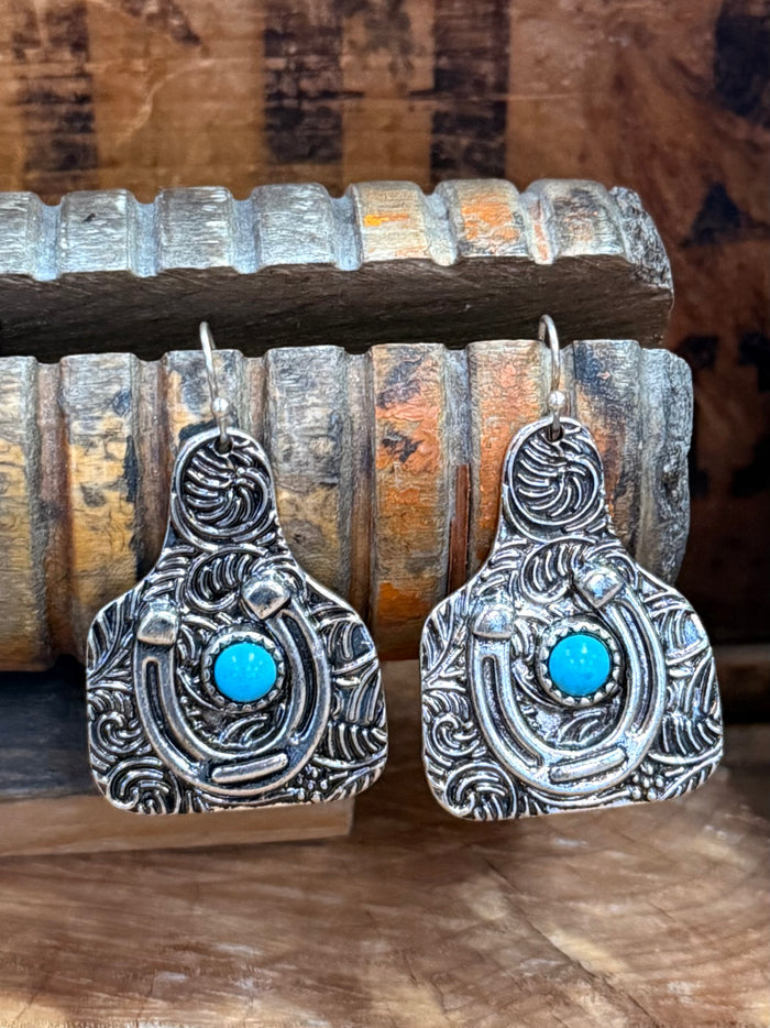 Silver horseshoe drop earrings with turquoise cabochon and engraved swirl detailing