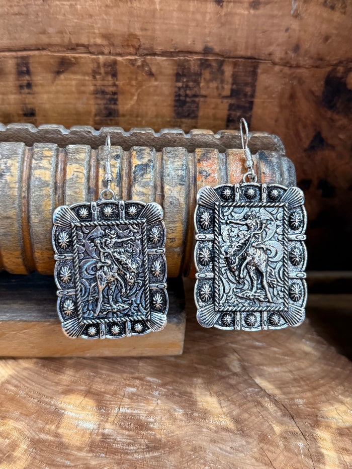 Silver-tone rectangular filigree earrings with engraved border and raised center details