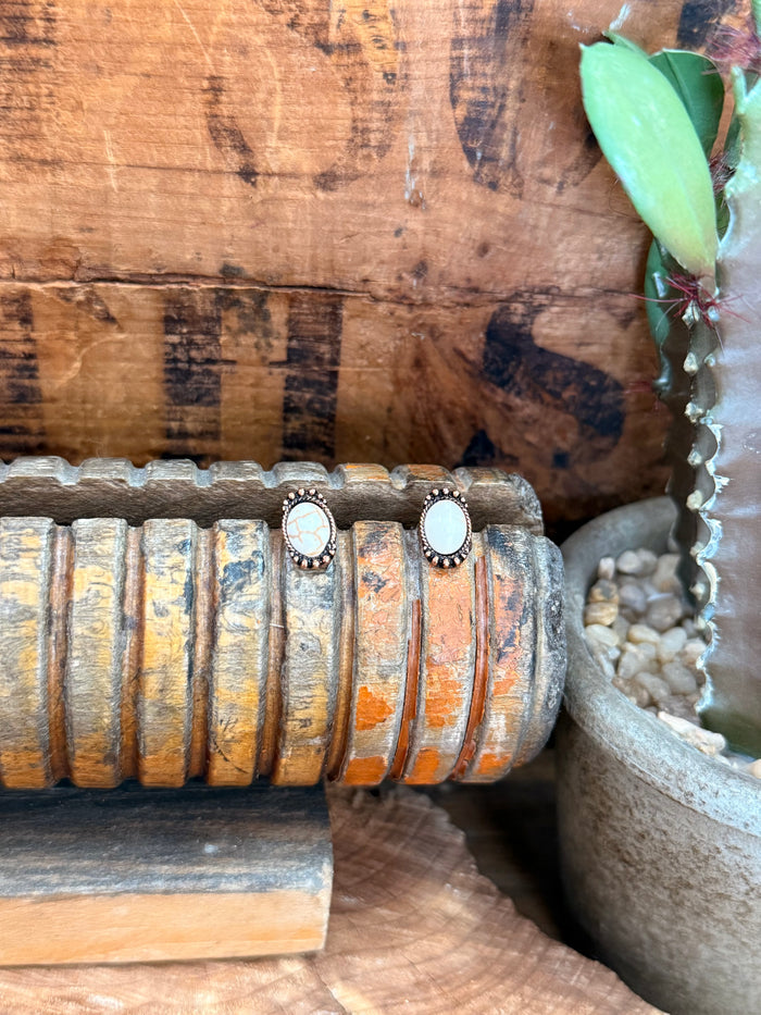 Copper oval stud earrings with white opal cabochon and textured bezel