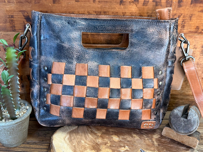 Distressed blue leather bag with tan-and-brown checker panel and top handle slot