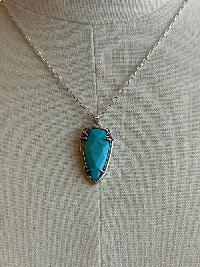 Turquoise arrowhead pendant necklace close-up on silver chain