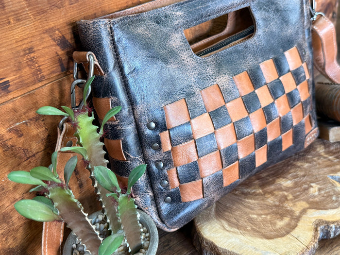 Distressed blue leather crossbody bag with tan-brown checker front and side hardware
