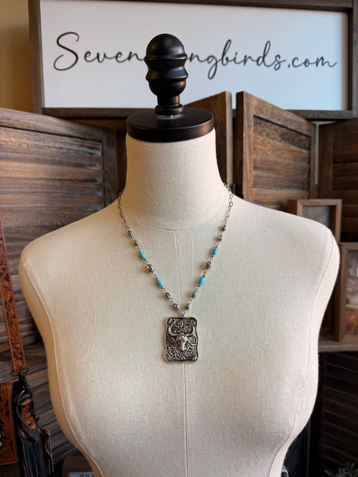 Cowskull pendant necklace with silver chain and turquoise bead accents