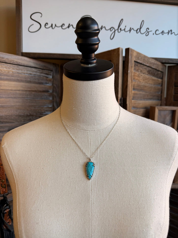Turquoise arrowhead pendant necklace on silver chain