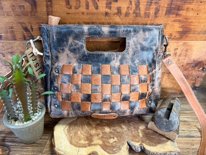 Distressed blue leather bag with tan checker panel, top handle, and shoulder strap
