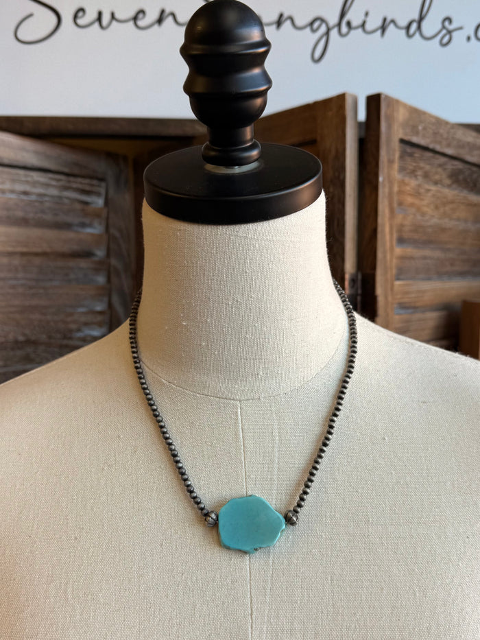 Turquoise chunk pendant necklace with turquoise pendant on a dark bead chain
