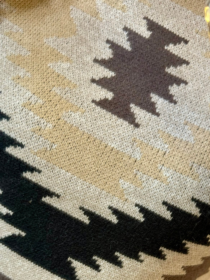 Crew sweater close-up in black and cream geometric zigzags Aztec knit pattern