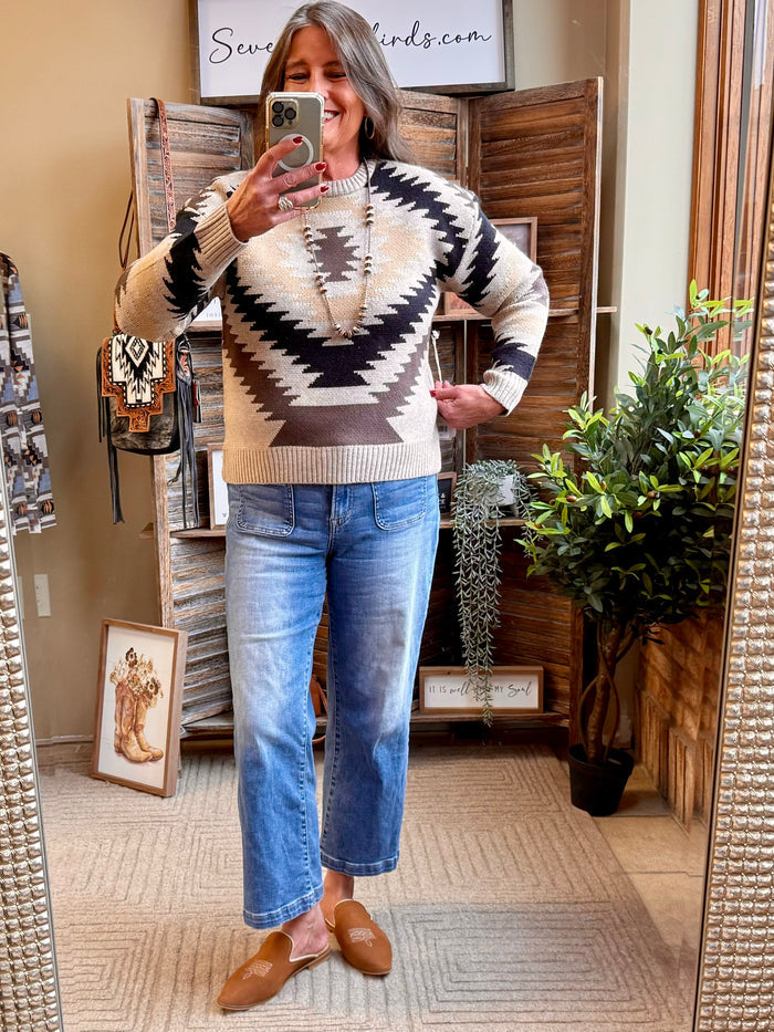 Geometric crew neck sweater with black, cream, and beige Aztec knit pattern