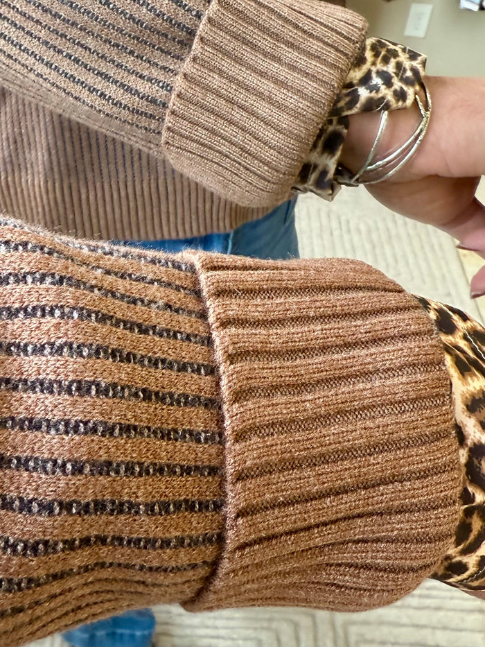 Ribbed knit sweater cuff with leopard print trim at wrist