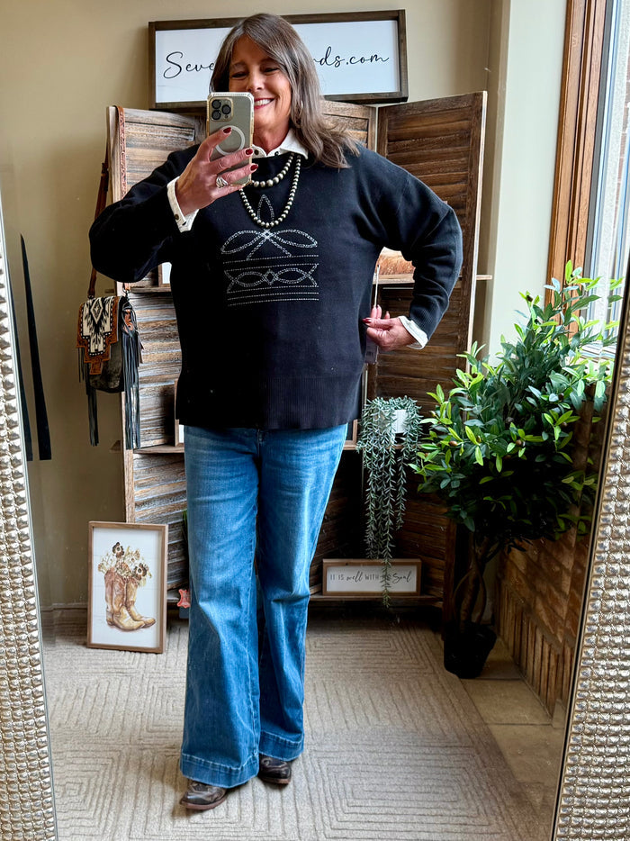 Dark crew neck sweater with stitched Nordic-style front pattern