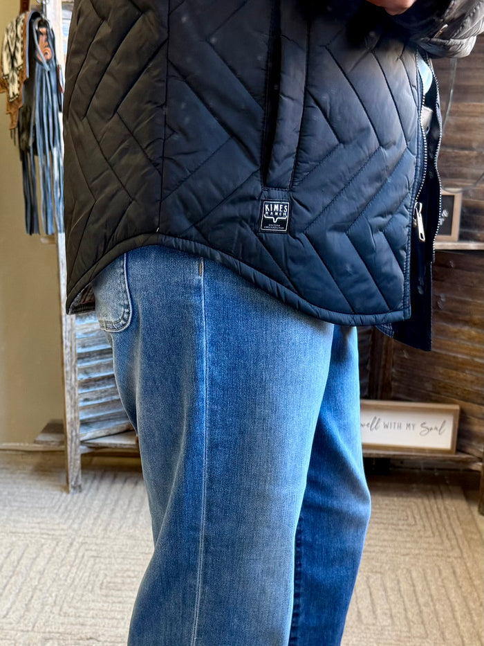 Navy quilted coat with zip front, logo patch on chest, cropped side view