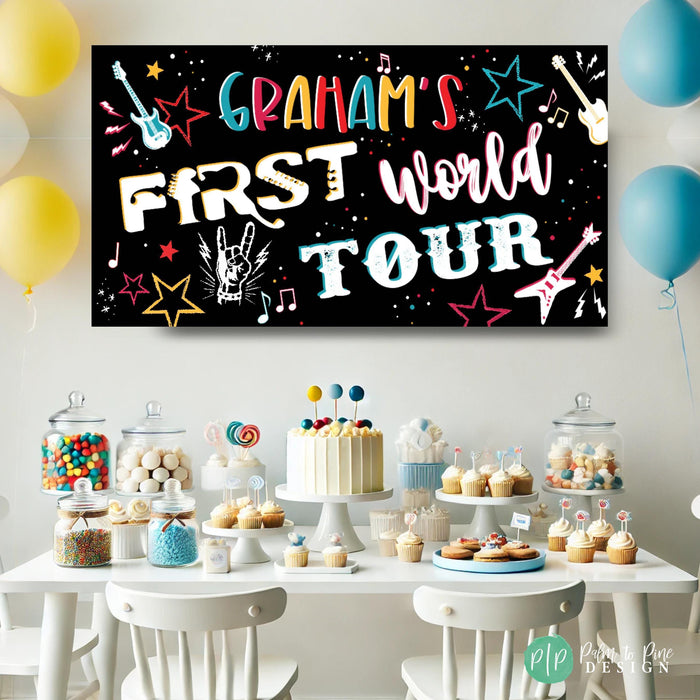 First Birthday Rock n Roll Banner in primary rainbow colors with electric guitars, music notes and a dessert table
