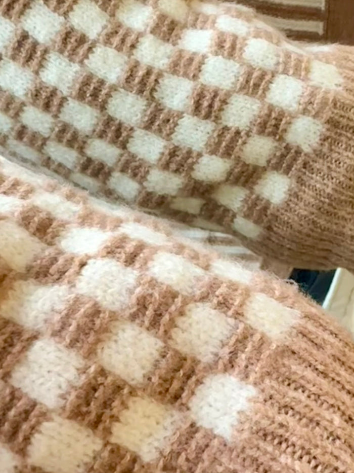 Close-up of tan and cream checker knit texture with horizontal stripe bands.