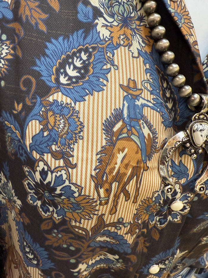 Damask blouse neckline close-up with gold-and-blue damask print and metallic buttons