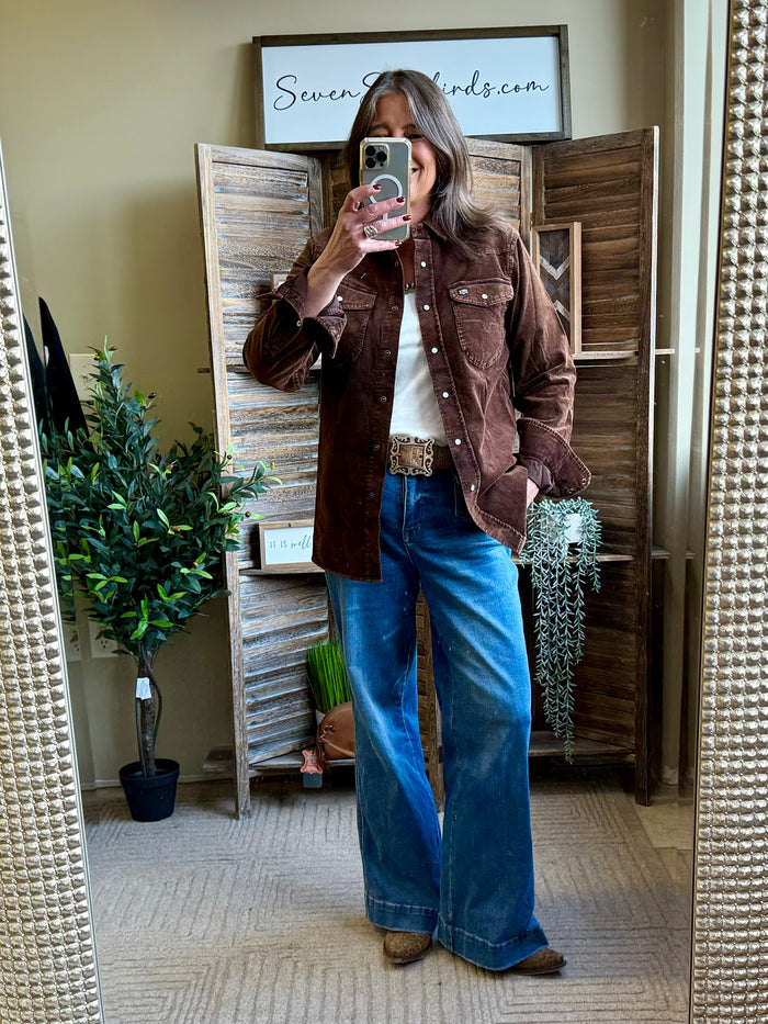 Dark brown corduroy shirt with button-front, two pockets, worn with wide-leg jeans