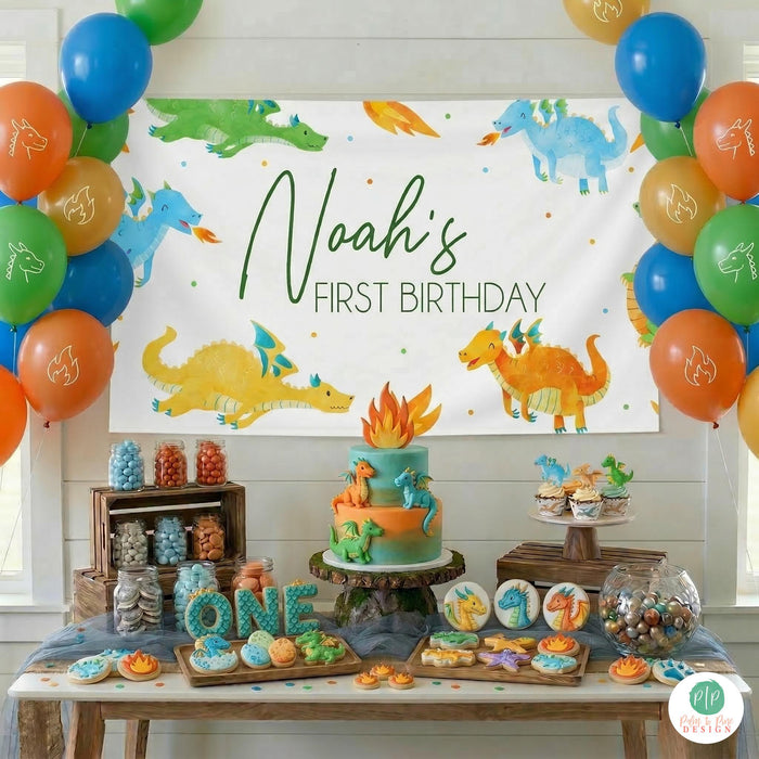 Dragon first birthday party dessert table with personalized banner and balloon bundles