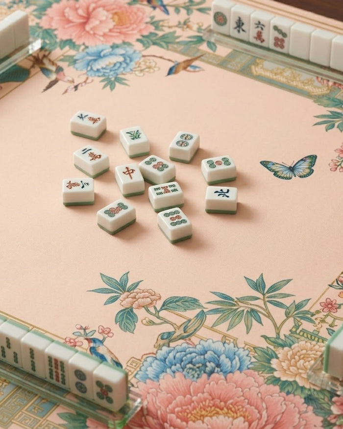 Floral mahjong playing mat with butterflies and Mahjong tiles on beige surface