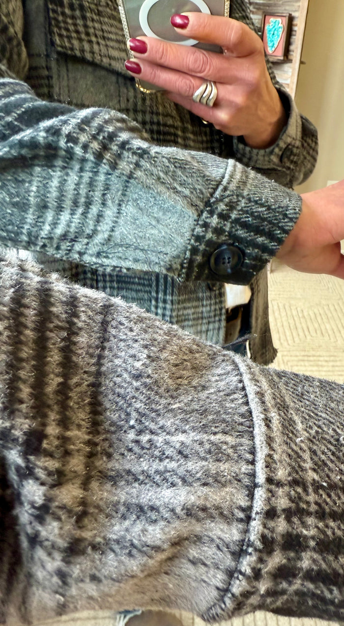 Gray plaid hooded coat close-up: button front and textured fabric