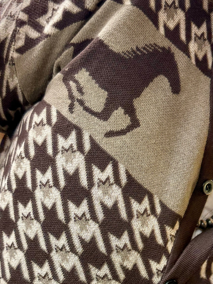 Close-up of brown-and-cream houndstooth horse pattern knit cardigan fabric