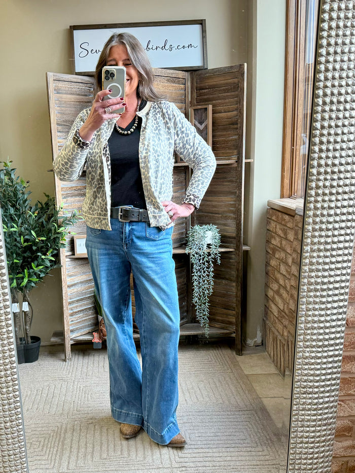 Leopard print cardigan worn with black top; collared open front and long sleeves