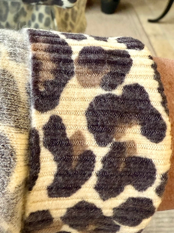 Leopard print cardigan close-up with cream knit and dark mottled spots