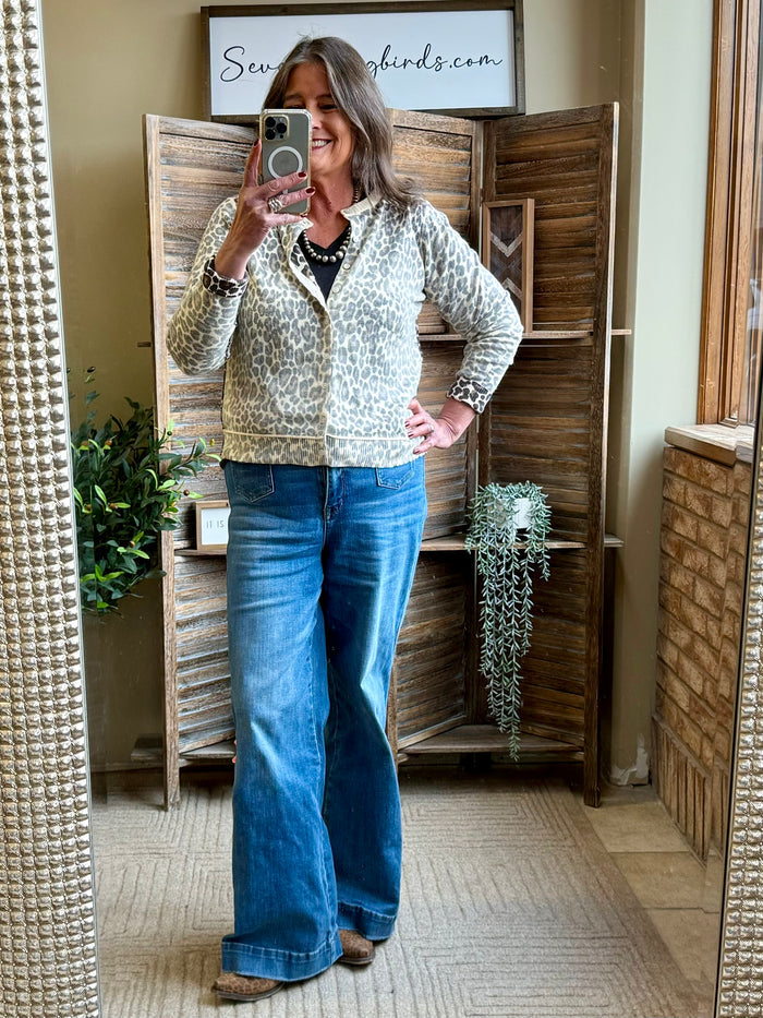 Leopard print cardigan with collared neckline, open front, long sleeves, ribbed hem