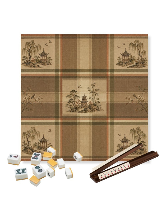 Square mahjong table mat with tan and brown plaid pattern and landscape motifs