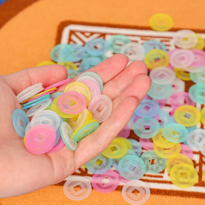 Multicolor translucent mahjong scoring chips with raised center icons