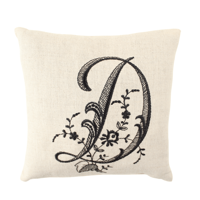 Monogram pillow with black D letter on white background