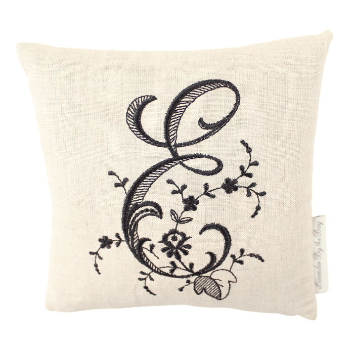 Monogramed pillow with black letter E on white background
