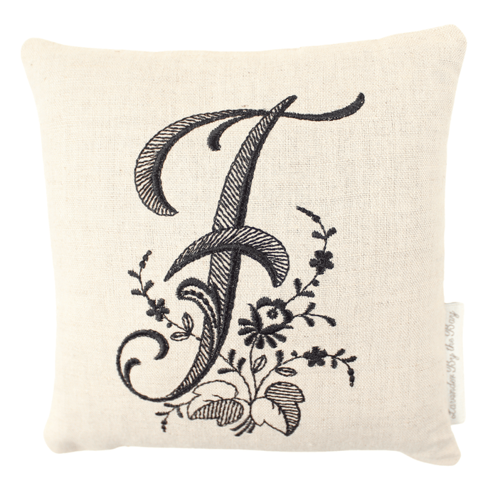 Monogrammed lavender pillow with black letter F on white background