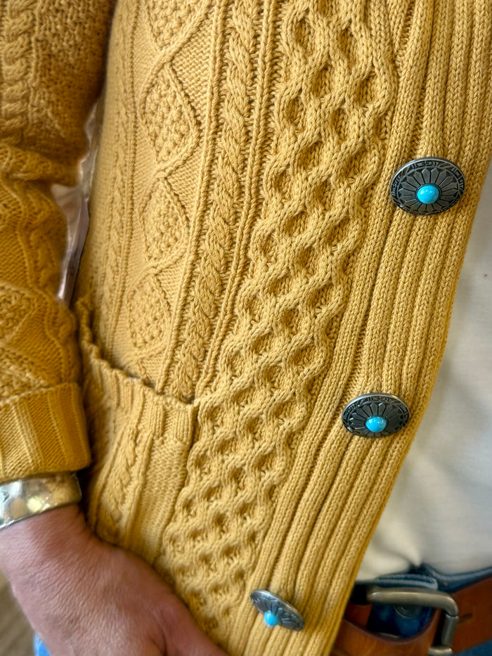 Mustard cable-knit cardigan with two-tone buttons and ribbed hem and cuffs