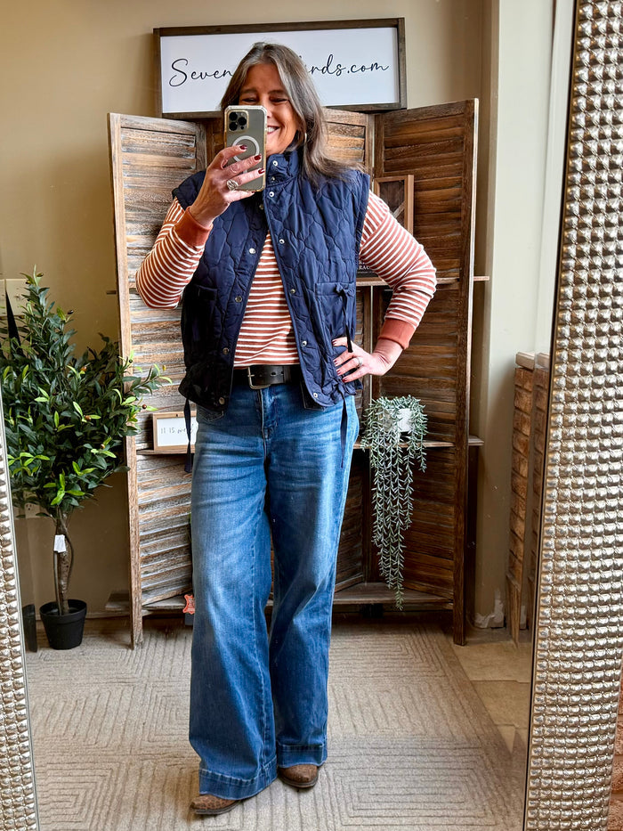 Navy quilted puffer vest with zip front and high collar