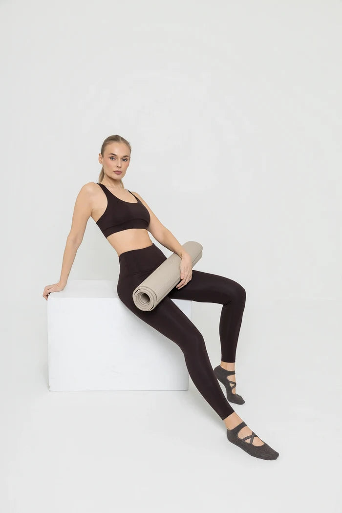 Woman wearing Tripulse sports bra and leggings set in terra brown