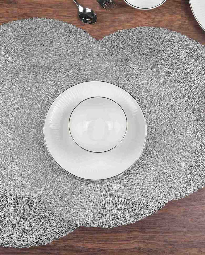 Silver round table mat with textured surface and centered plate