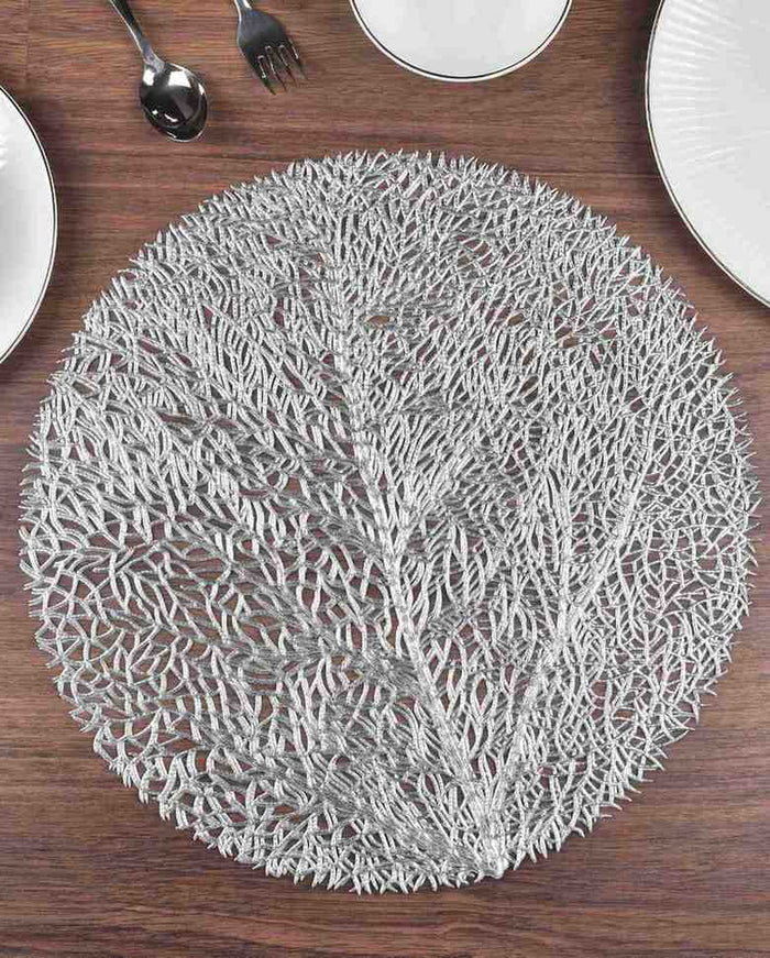 Silver round metallic table mat with airy woven branches and textured center